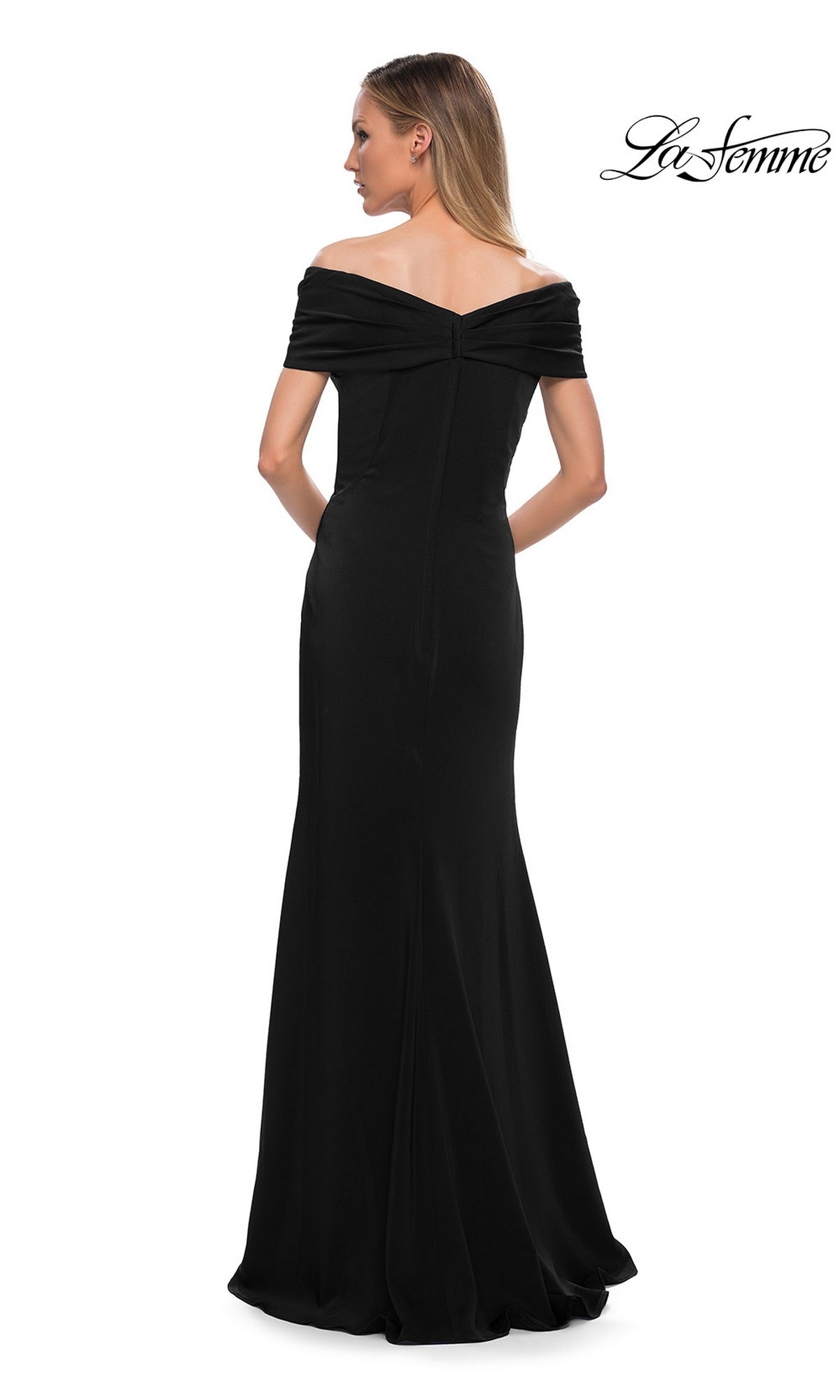 A woman wearing the La Femme 29537 long formal dress, a minimalist chic, off-the-shoulder, floor-length black gown, stands with her back to the camera against a white background.